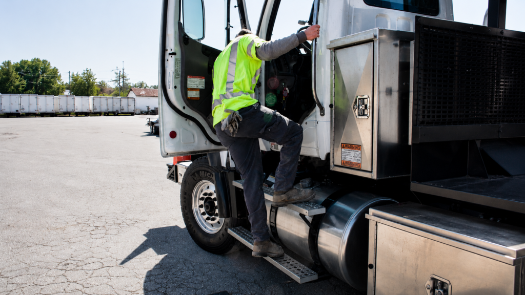 Image of man getting out of large vehicle