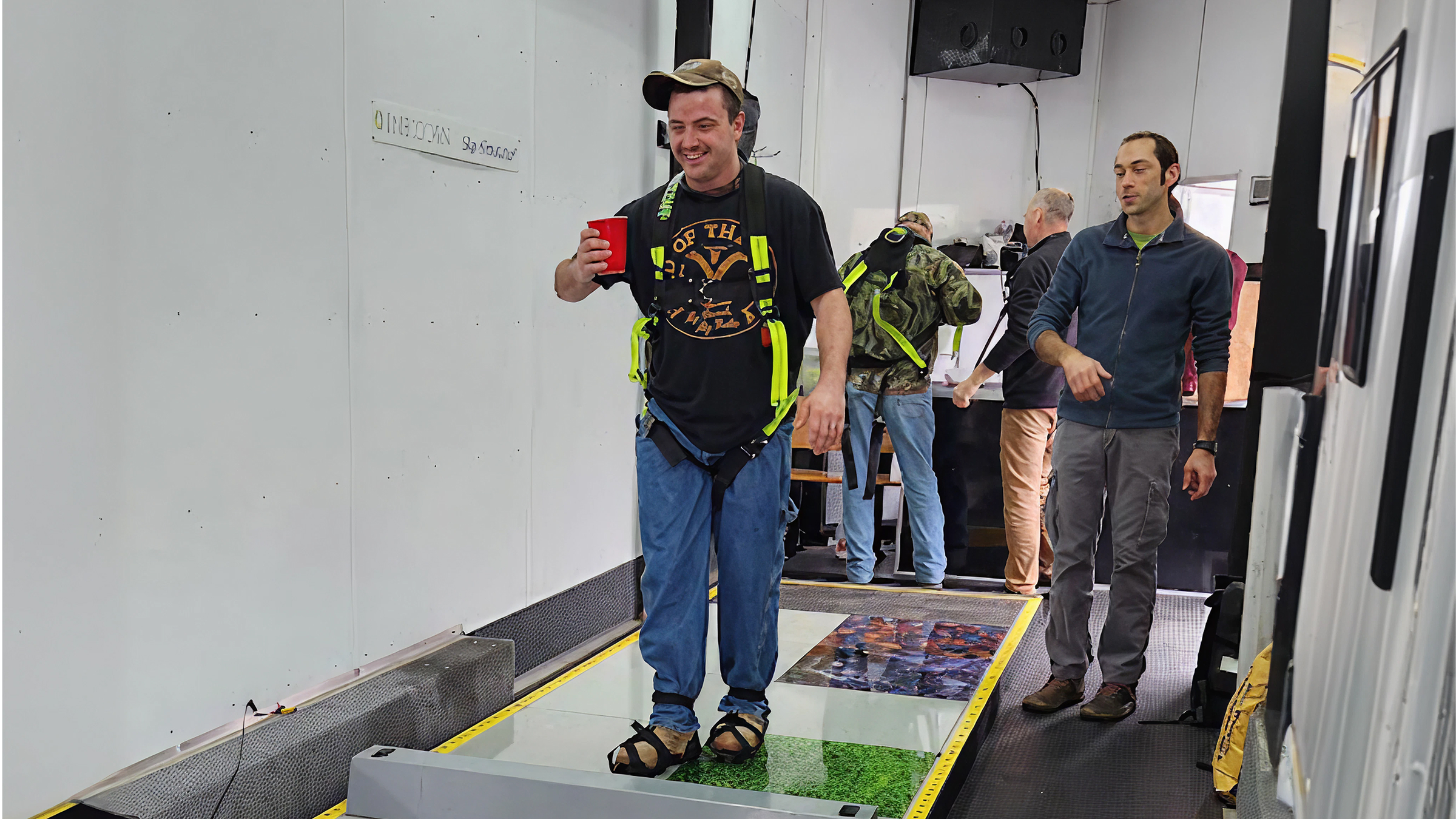 Man walking on Slip Simulator with trainer beside him