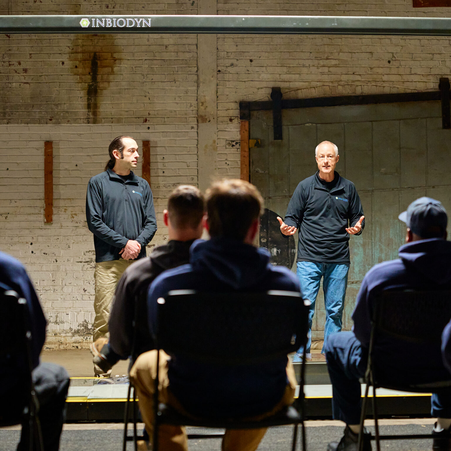Image of Inbiodyn trainers teaching a class of workers
