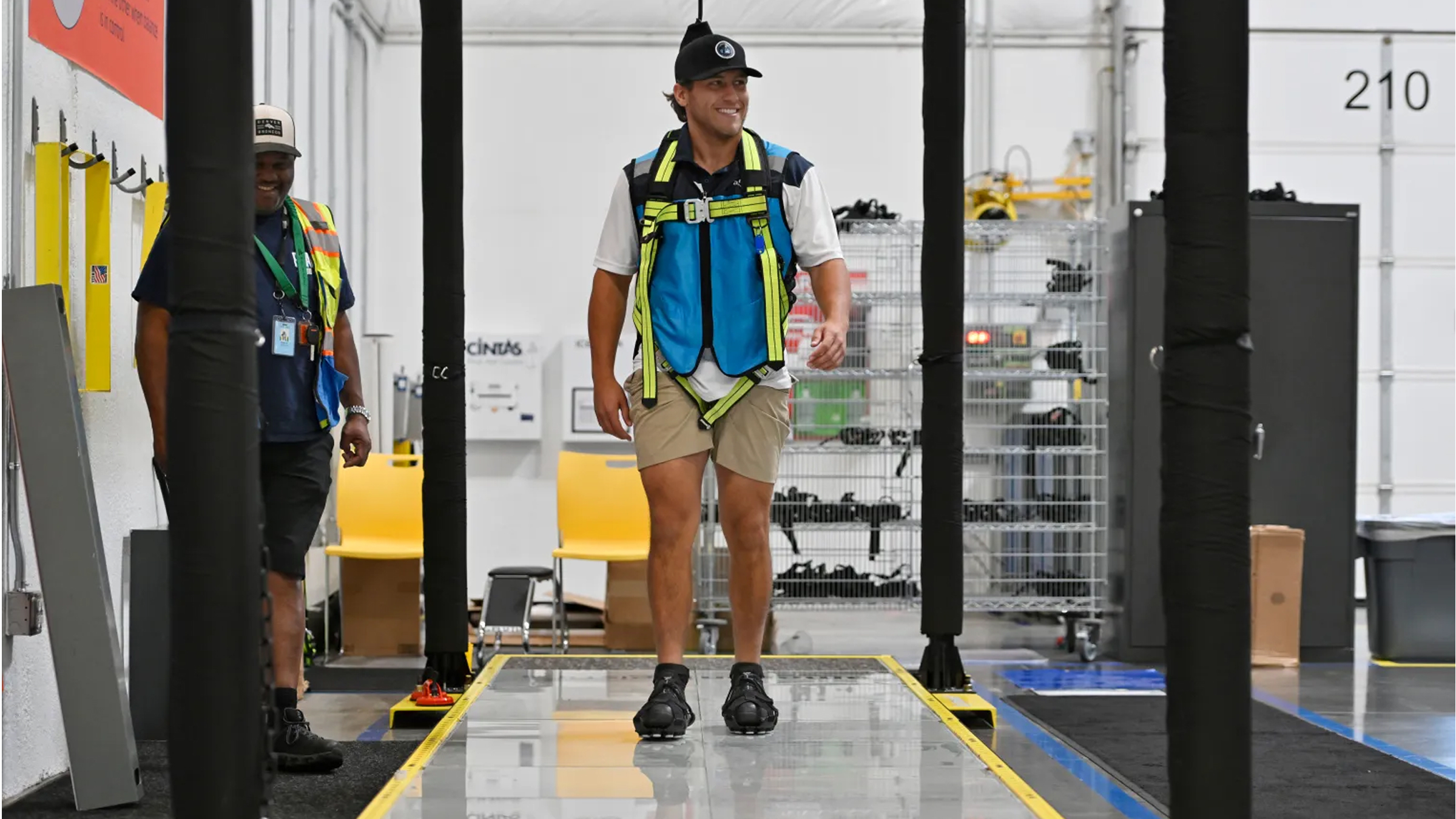 Man walking on Slip Simulator with trainer beside him